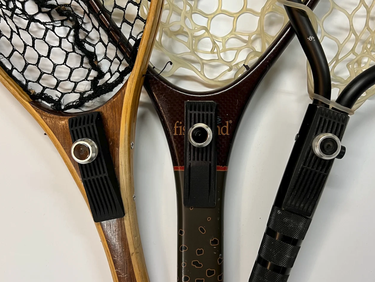 Broder Net Clip Extra Mounts installed on wood, carbon fiber, and metal fly fishing landing net handles
