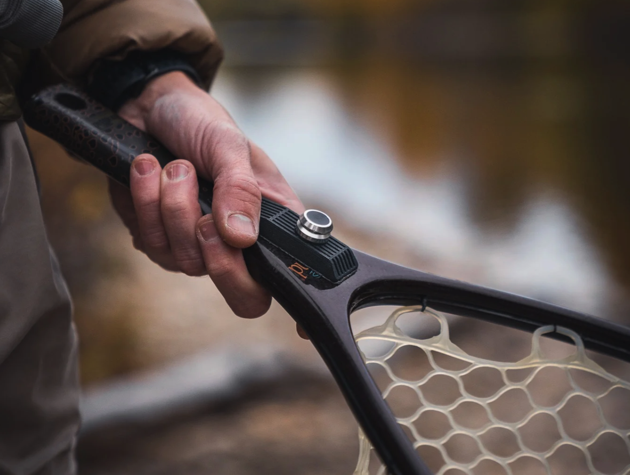Broder Net Clip net mount attached to a landing net handle with magnetic connector for fast fly fishing net return