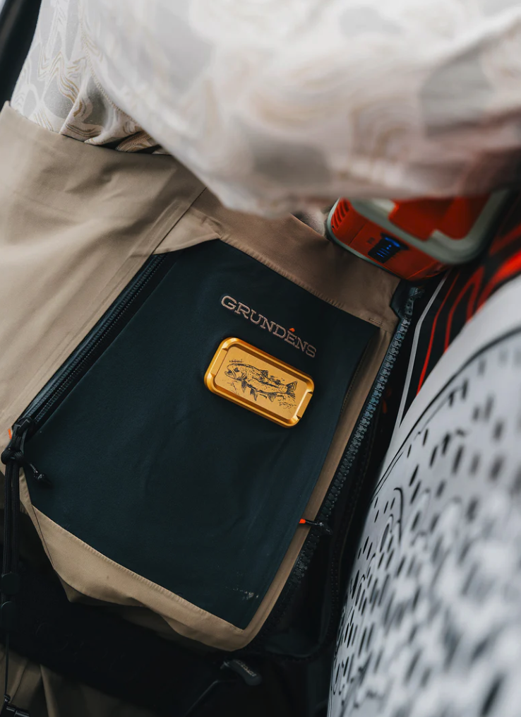 Angler wearing waders with Cling Mag Grab Doublestack: Danforth Artwork Limited Edition Trout style on it