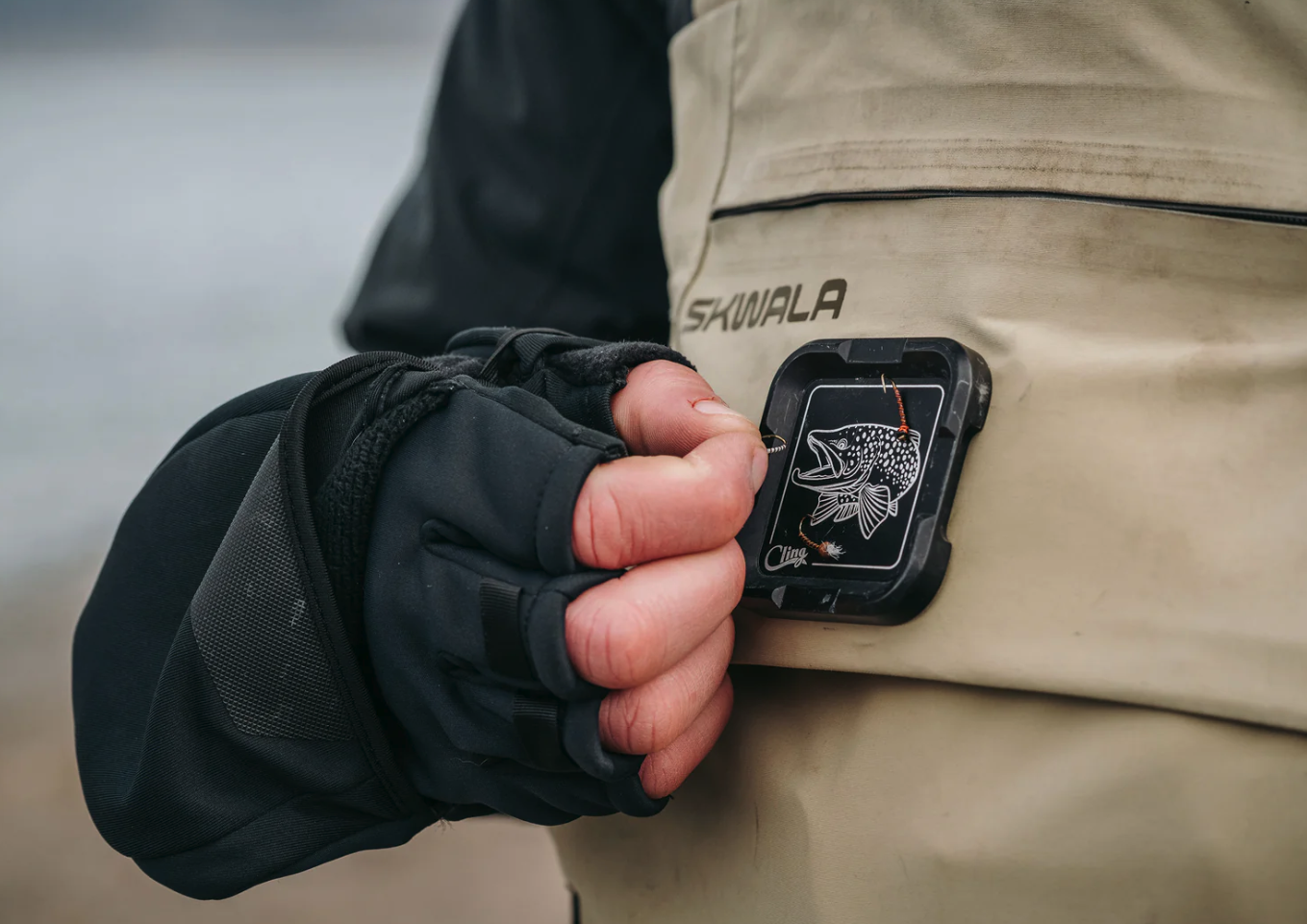 Cling Mag Grab Plus in black on waders with flies being put on