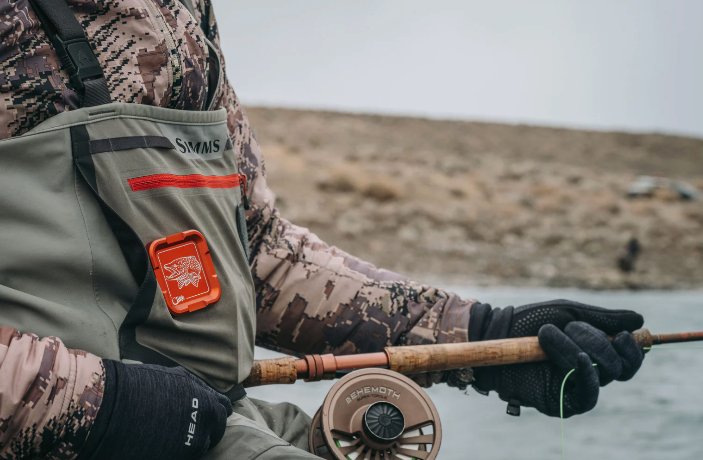 Cling Mag Grab Plus in orange on waders with angler holding rod