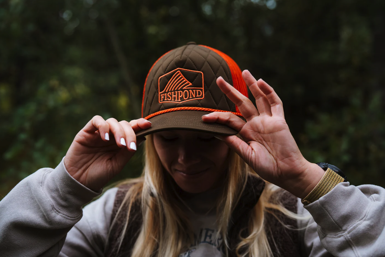 Woman wearing Fishpond Dorsal Fin Trucker Hat