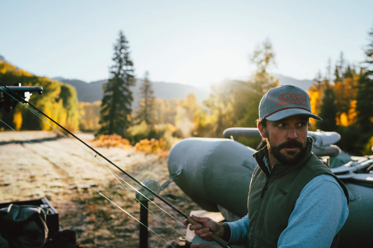 Angler with fly rod wearing Fishpond Heritage Corduroy Hat Tempest