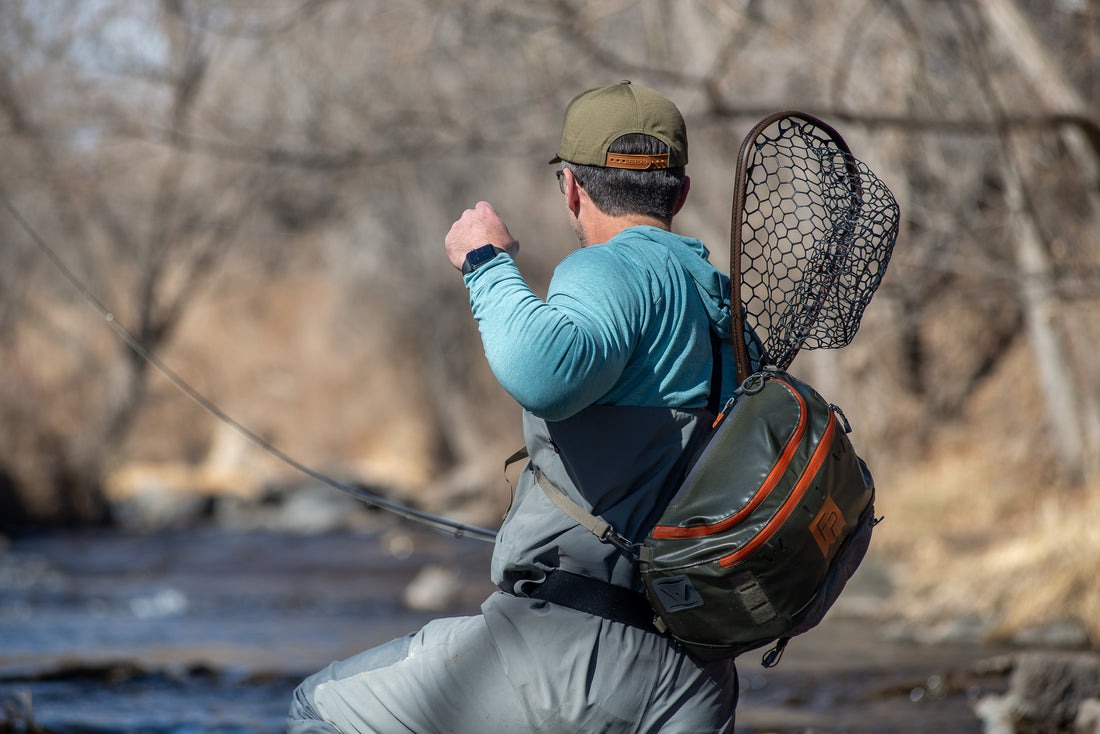 Fishpond Nomad Canyon Net 2.0 secured in backpack net slot while fly fishing