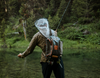 Angler fishing with Fishpond Nomad Canyon Net Colorado Cutty in sling pack