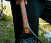 Man holding handle of Fishpond Nomad Canyon Net Colorado Cutty edition