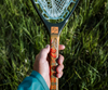 Hand holding Fishpond Nomad Canyon Net Colorado Cutty edition.