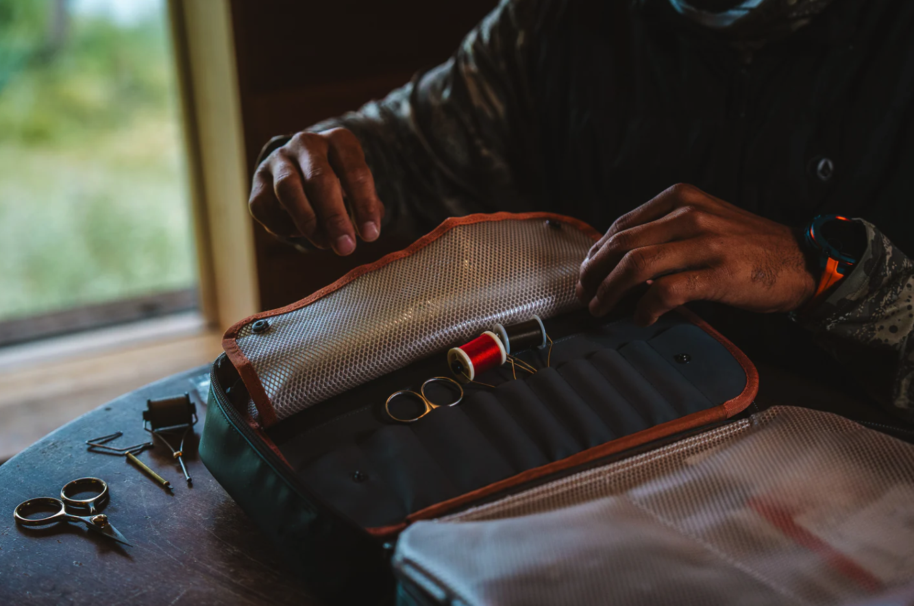 Fly tyer opening loaded Fishpond Backwater Fly Tying Kit