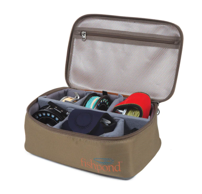 Angler organizing reels in Fishpond Ripple Reel Case—best fly fishing reel case with removable dividers.