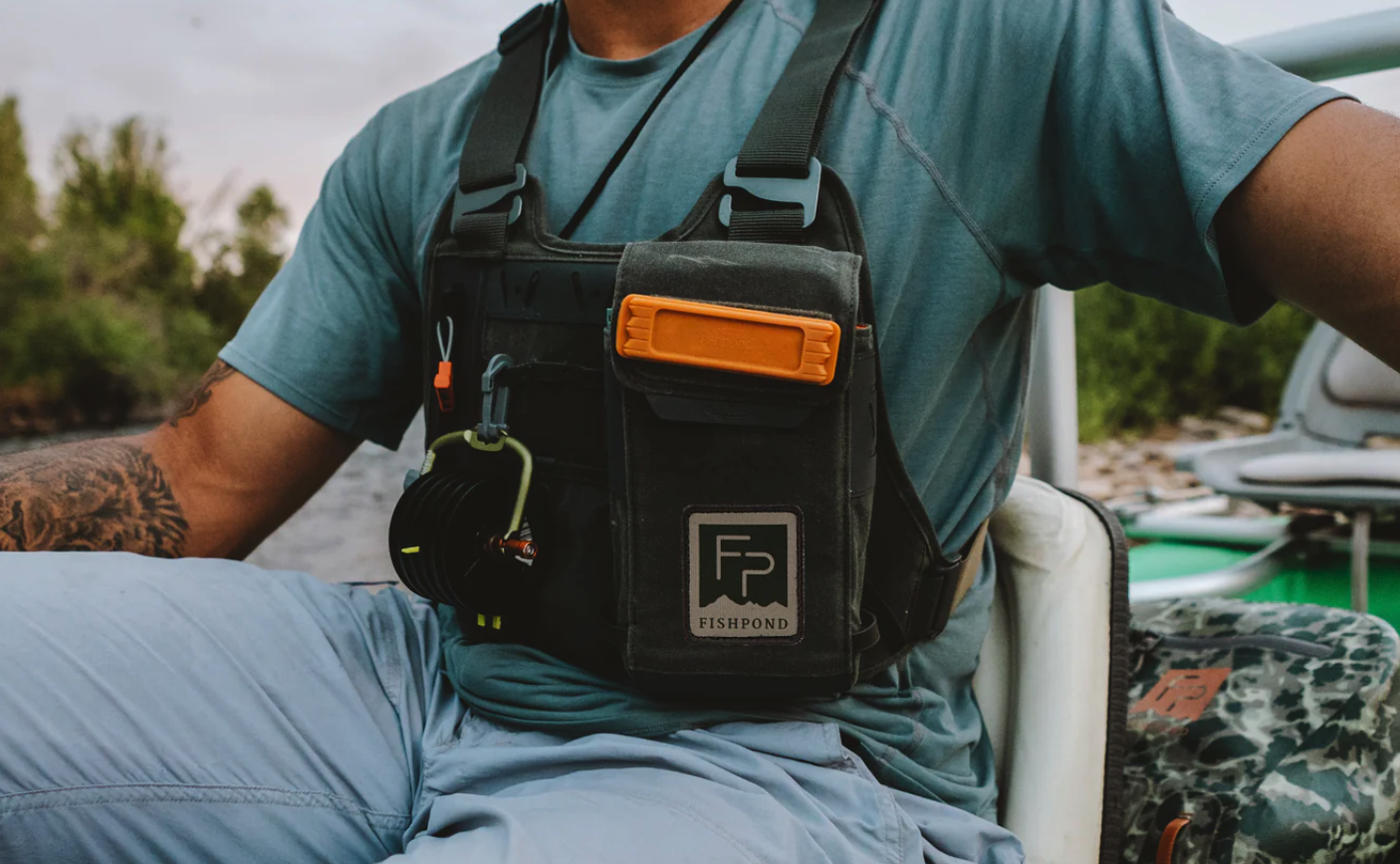 Angler rowing boat wearing  Fishpond Stormshadow Chest Pack Duskwood