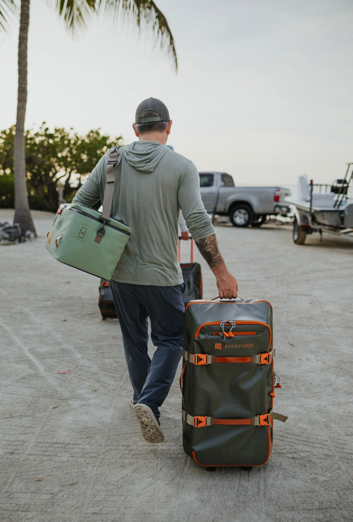 Man rolling Fishpond Stormshadow Medium Rolling Duffel
