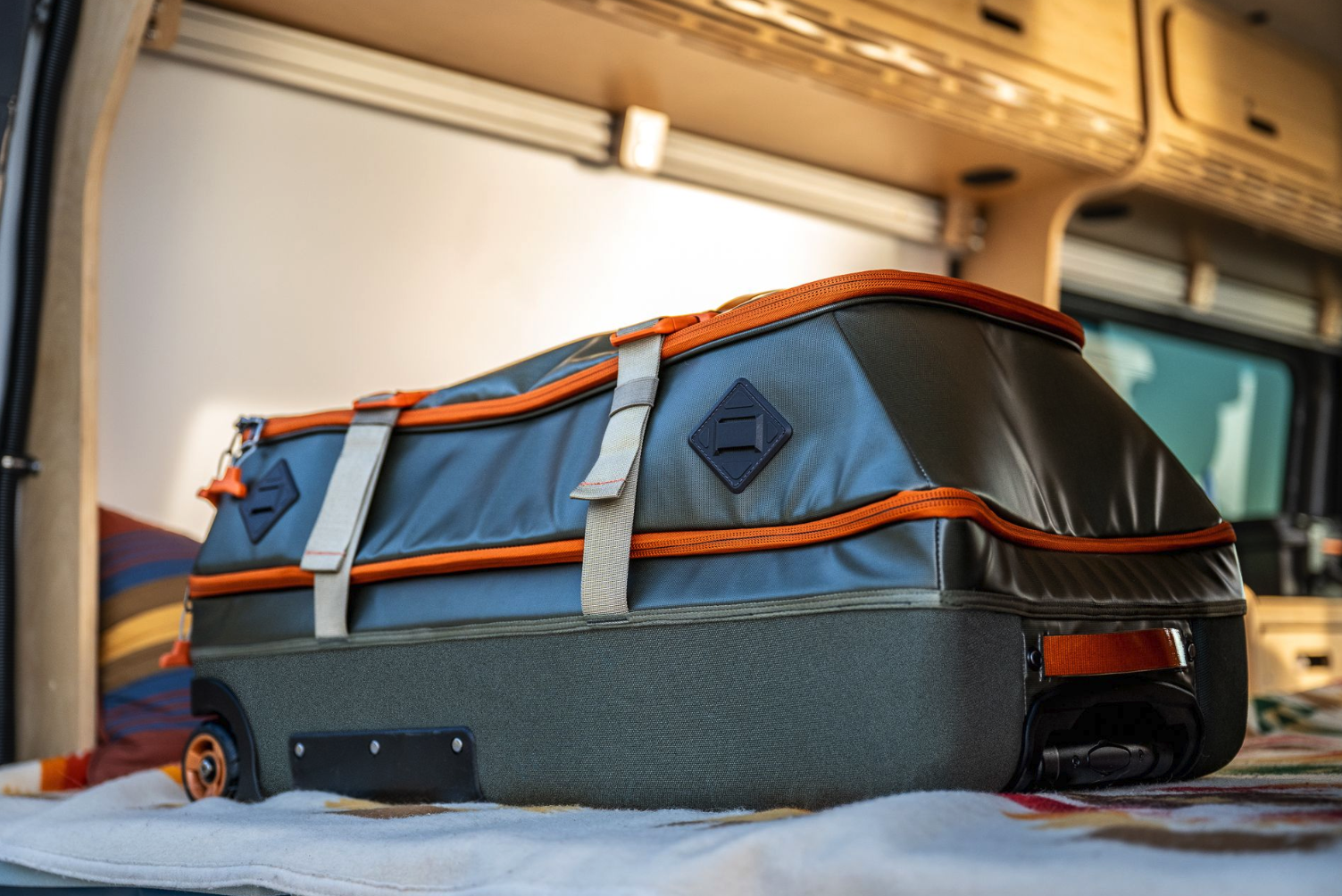 Detailed side view of Fishpond Stormshadow Medium Rolling Duffel