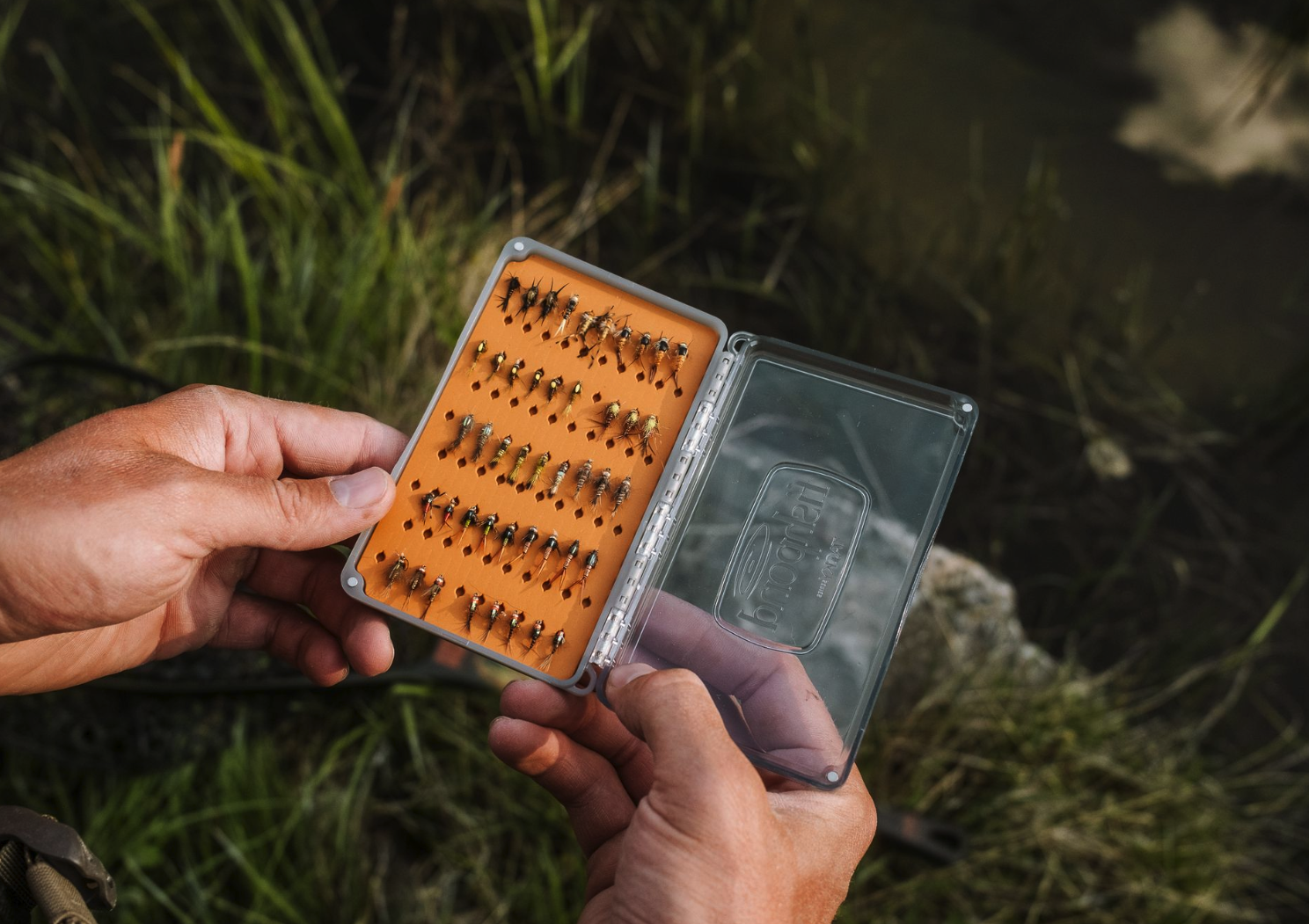 Angler holding open  Tacky Day Pack Fly Box Burnt Orange