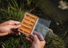 Angler holding open  Tacky Day Pack Fly Box Burnt Orange
