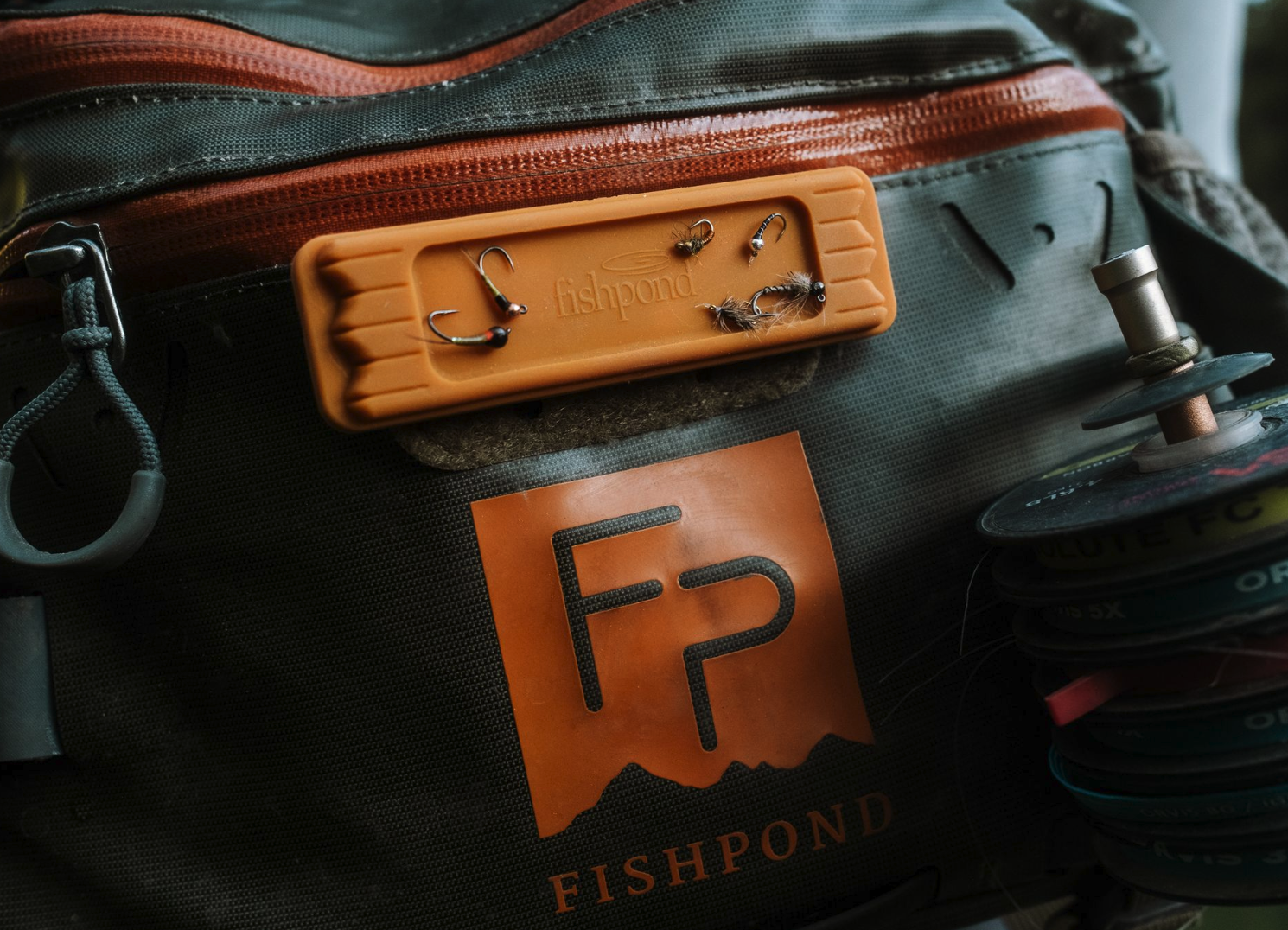 Close up of  Fishpond Tacky Fly Dock MagPad Burnt Orange on hip pack