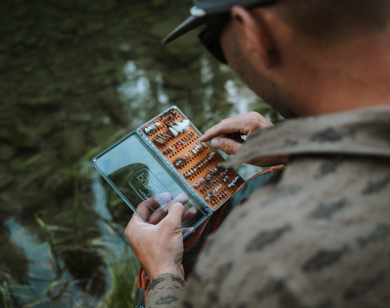 Angler picking fly from  Tacky Original Fly Box Burnt Orange