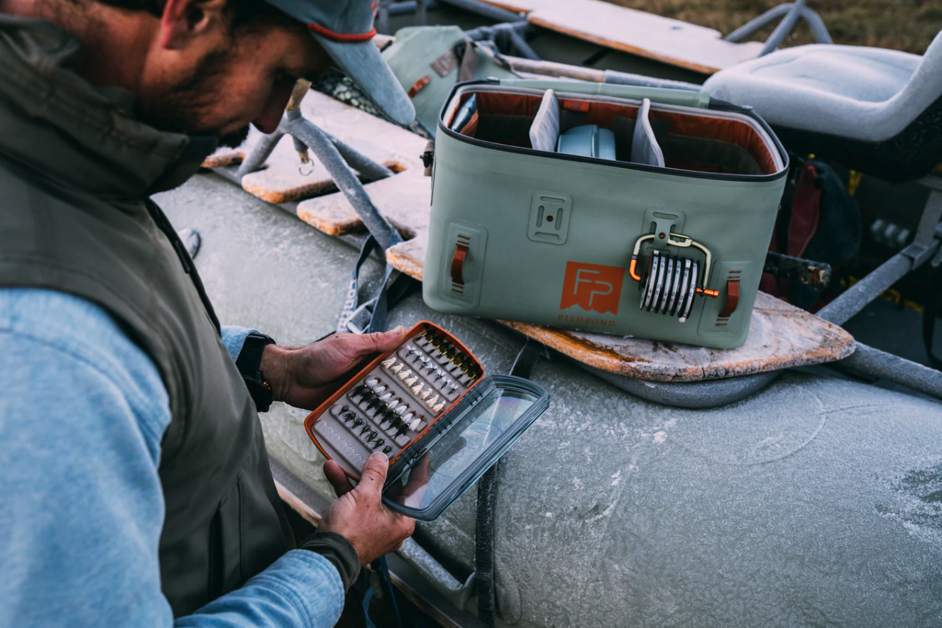 Angler looking into open Fishpond Tacky Pescador Clear Lid Fly Box Medium