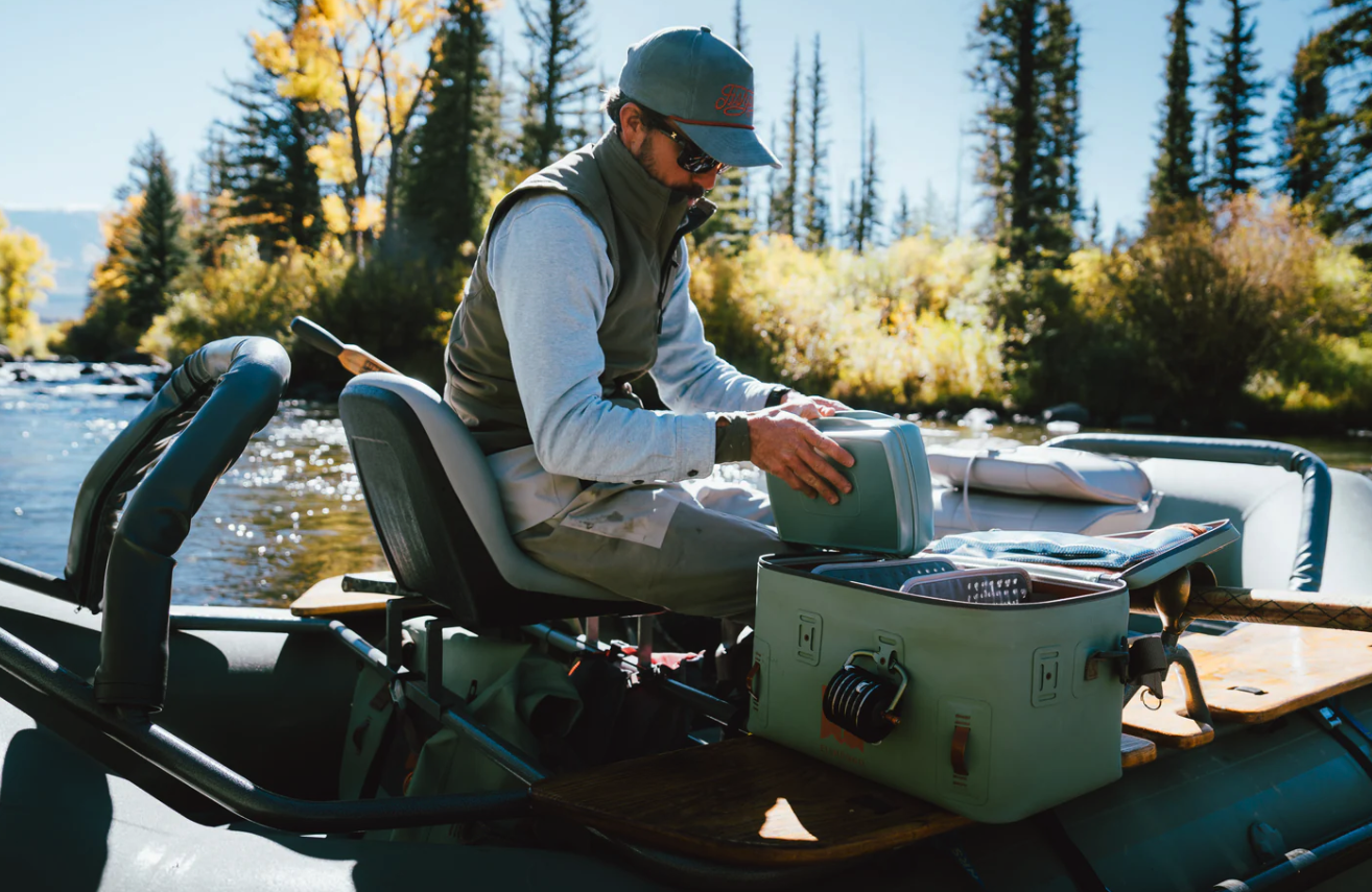 Angler in drift boat pulling out Fishpond Tacky Pescador Dynamic Foam Fly Box XL
