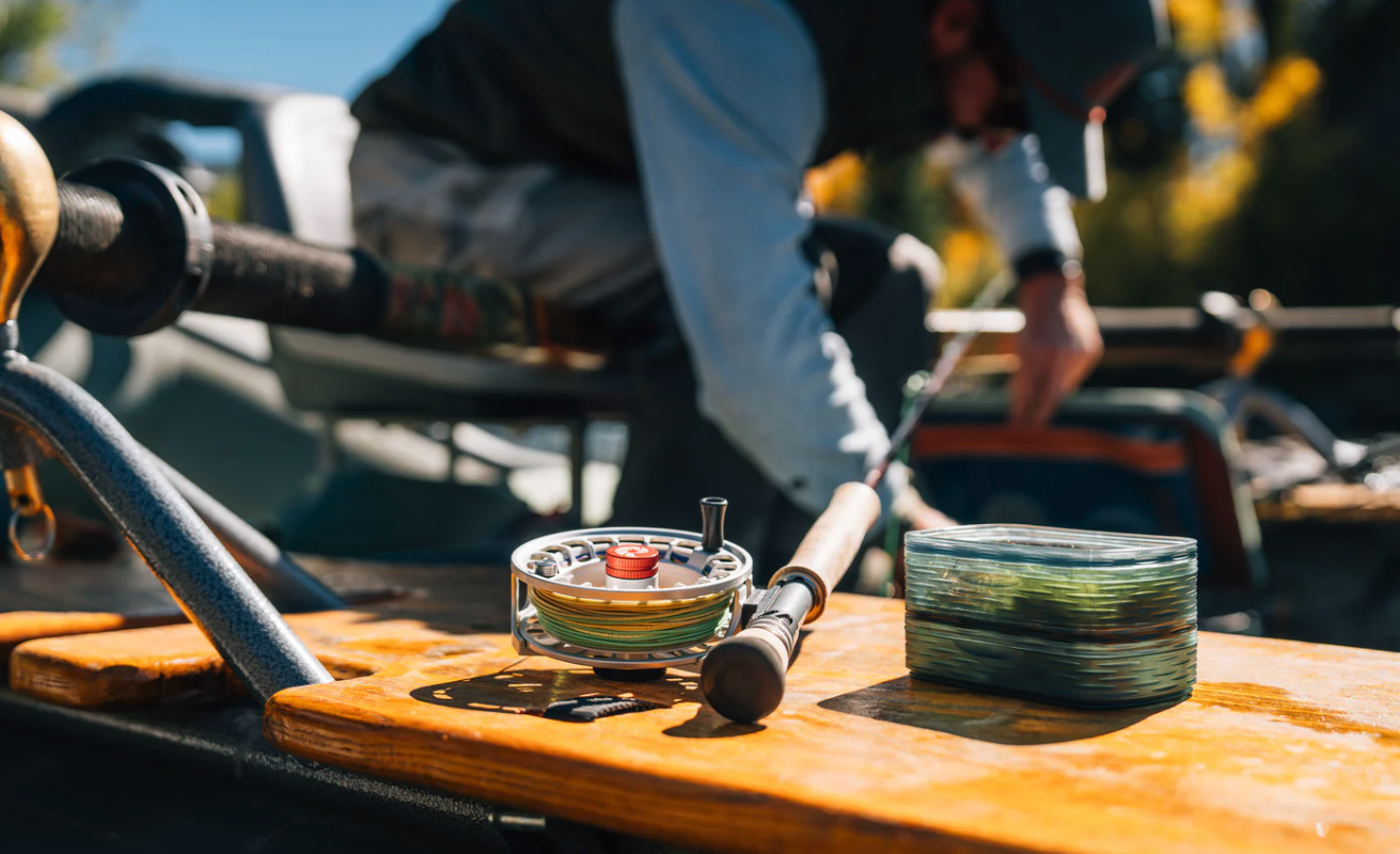 Stacked Fishpond Tacky Predator Fly Puck on drift boat by fly rod