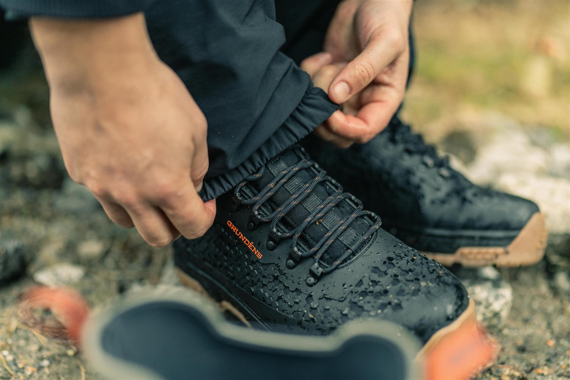 Lightweight rubber sole fishing boots with water resistant upper being worn