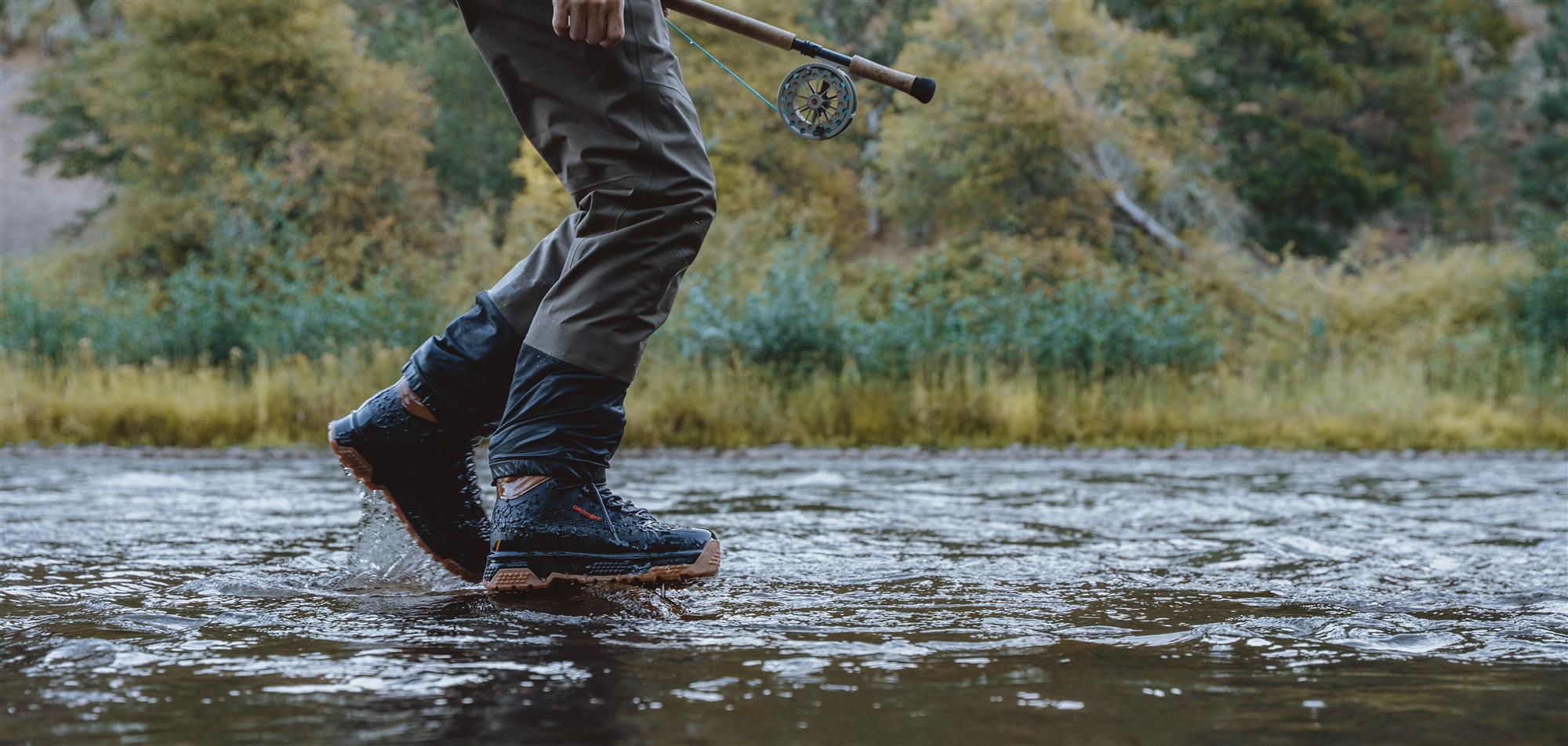 Fly fishing wading boots crossing stream durable rubber outsole performance