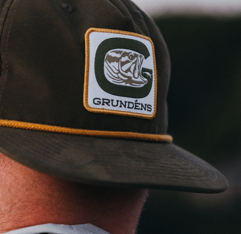 Classic Rope Hat by Grundens with a retro design, breathable mesh back, and adjustable snap closure.