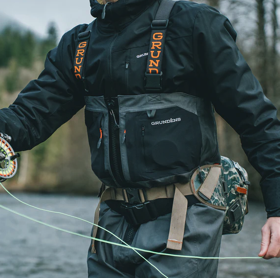 Angler fishing in Grundens Turbulence Hybrid Hoodie under waders