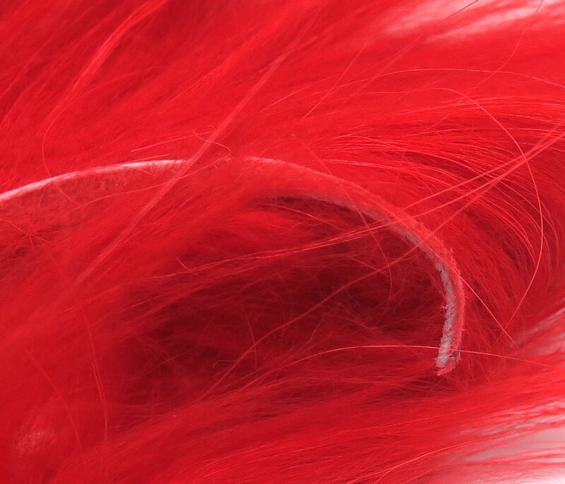 Red Fin Raccoon Zonker strip, striking and intense, designed for attracting predatory fish.