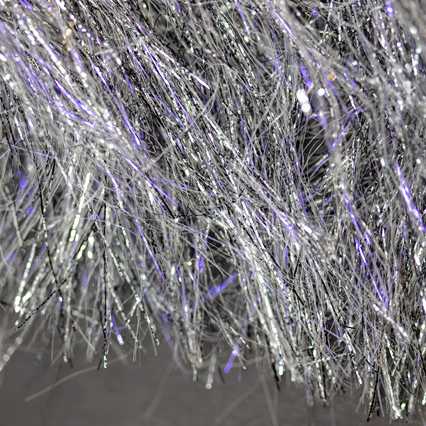 Create baitfish body effects with Senyo's Freckled Wrap in fly tying projects.