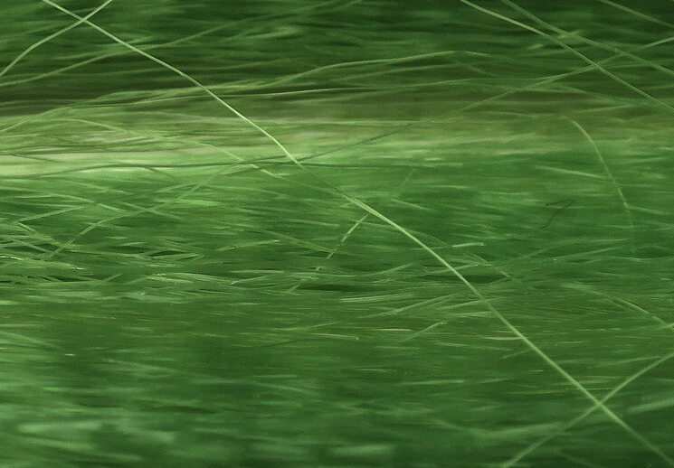 Close-up of Unique Hair synthetic fibers, highlighting texture and color variety.