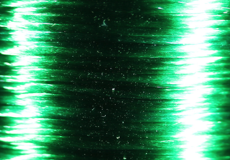 Translucent Veevus Floss in green highlander, ideal for subtle yet impactful fly tying applications