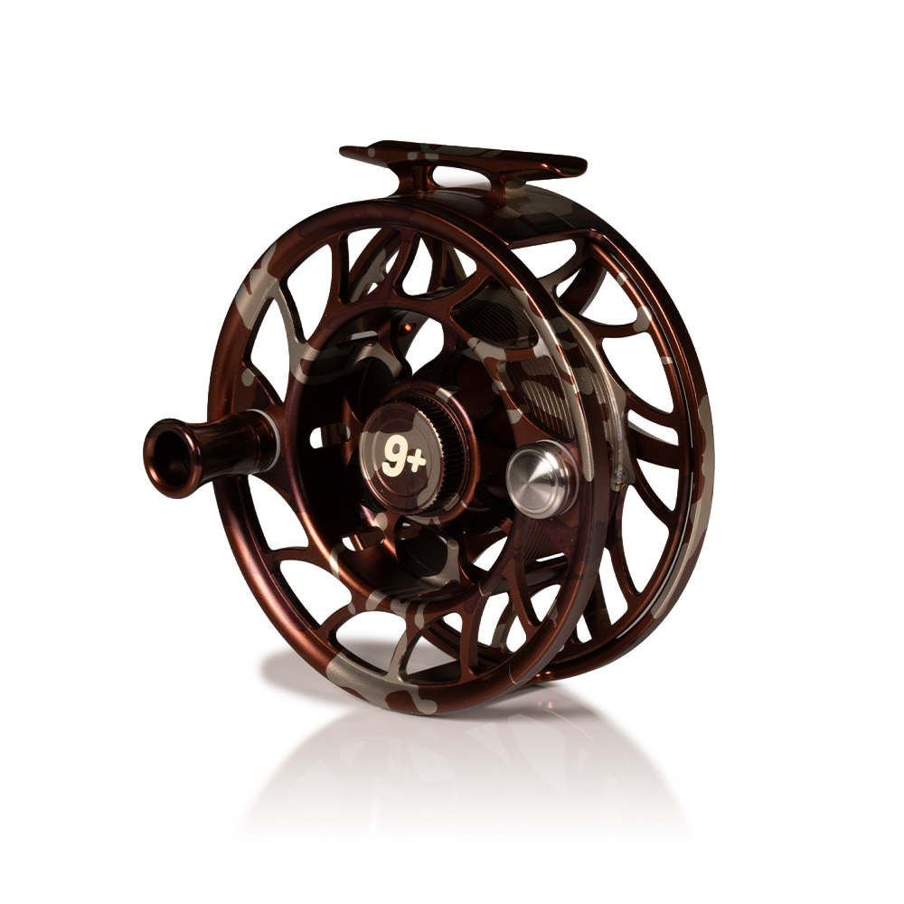 Hatch Iconic 9 Plus camo fly reel angled view showing drag knob handle and large arbor spool for saltwater fly fishing
