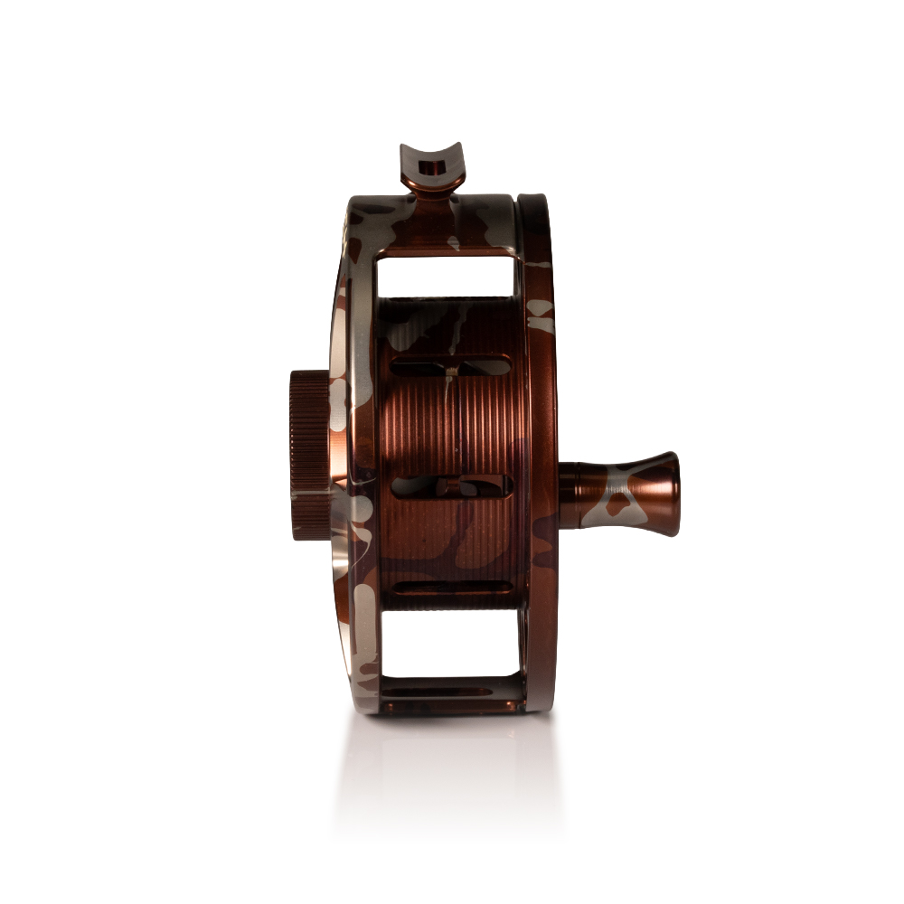 Hatch Iconic 9 Plus camo fly reel side profile showing wide spool drag housing and reinforced frame for saltwater durability