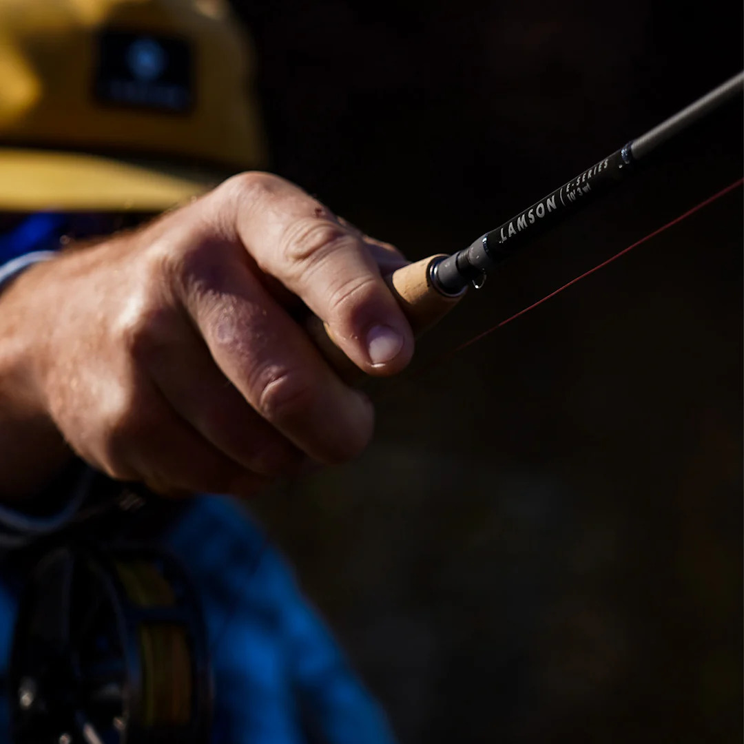 Angler holding the Lamson E-Series while fishing
