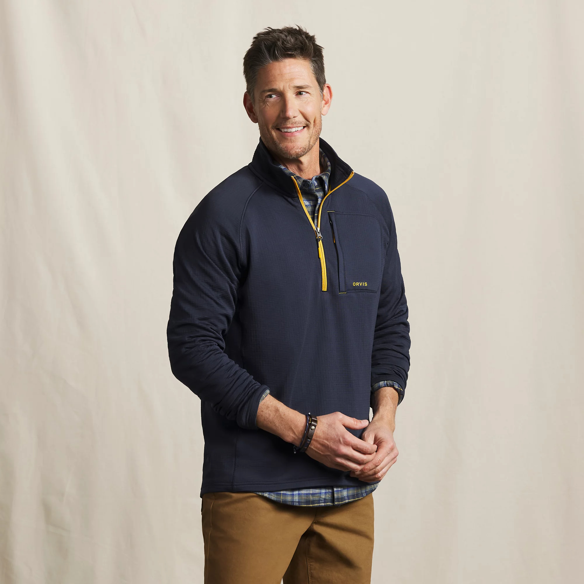 Men's Orvis Horseshoe Hills navy quarter zip fleece with chest pocket, worn as a lightweight outdoor layering pullover