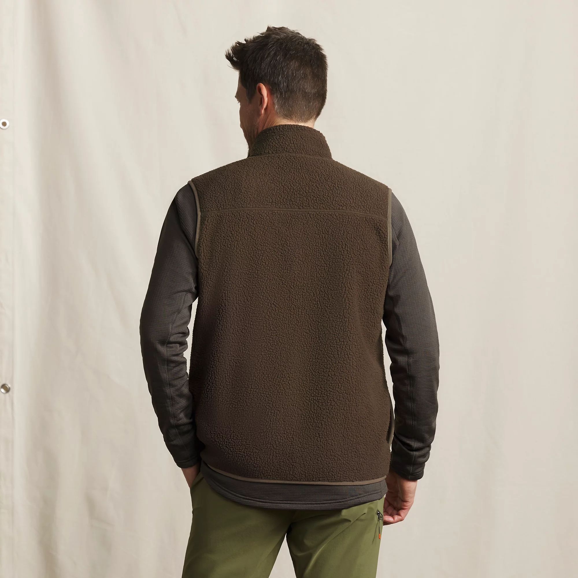 Back view of men's Orvis Mad River sherpa fleece vest in brown, showing soft fleece construction for cool-weather layering.