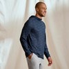 Profile view of model wearing the Orvis Sun Defense Hoodie