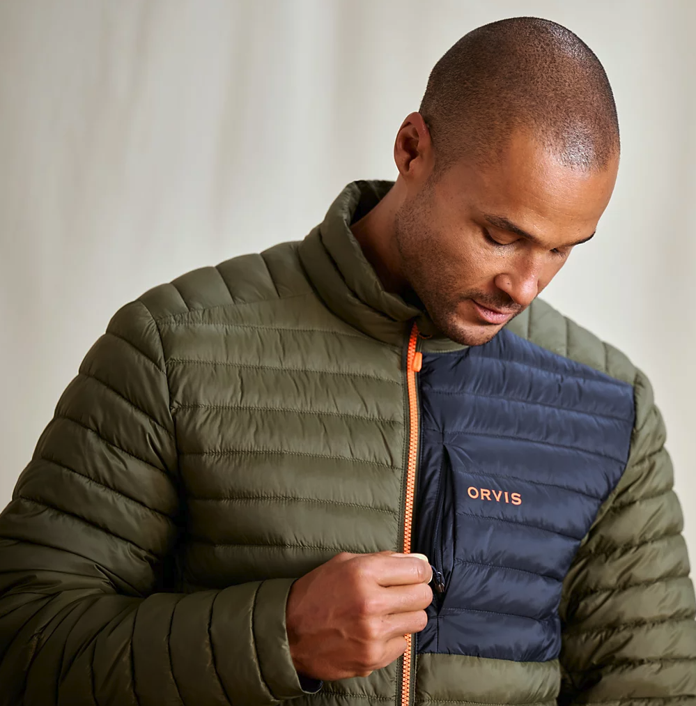 Model zipping up Orvis Drift Insulated Jacket Tarragon color