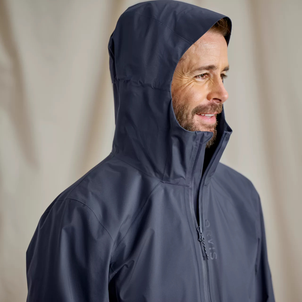 Model showing the Orvis Men's Ultralight Storm 2.5L Jacket with hood up
