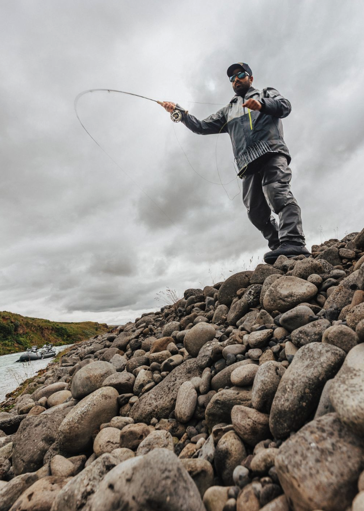 Angler standing on rocks and casting Orvis Recon Freshwater Fly Rod