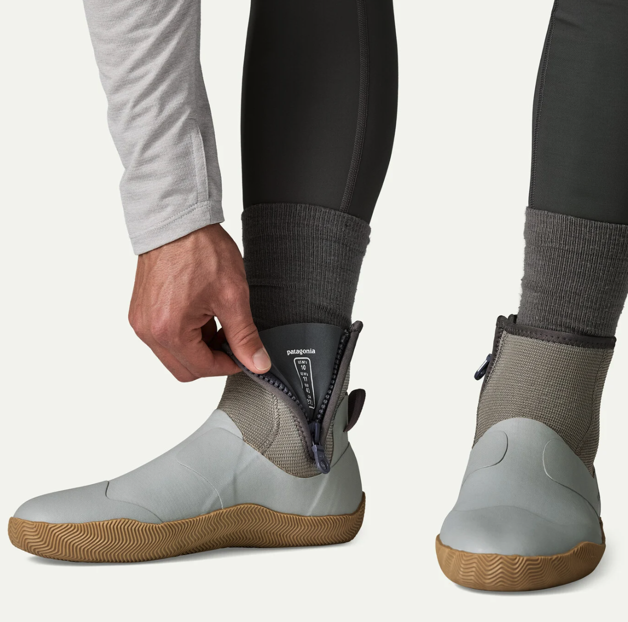 Angler opening the side zipper on Patagonia Salt Wading Booties, demonstrating easy entry for saltwater flats fishing.