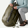 Man lashing fly rod tube to Patagonia Guidewater Duffel 80L