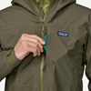 Fly box going into chest pocket of Patagonia Boulder Fork Rain Jacket.