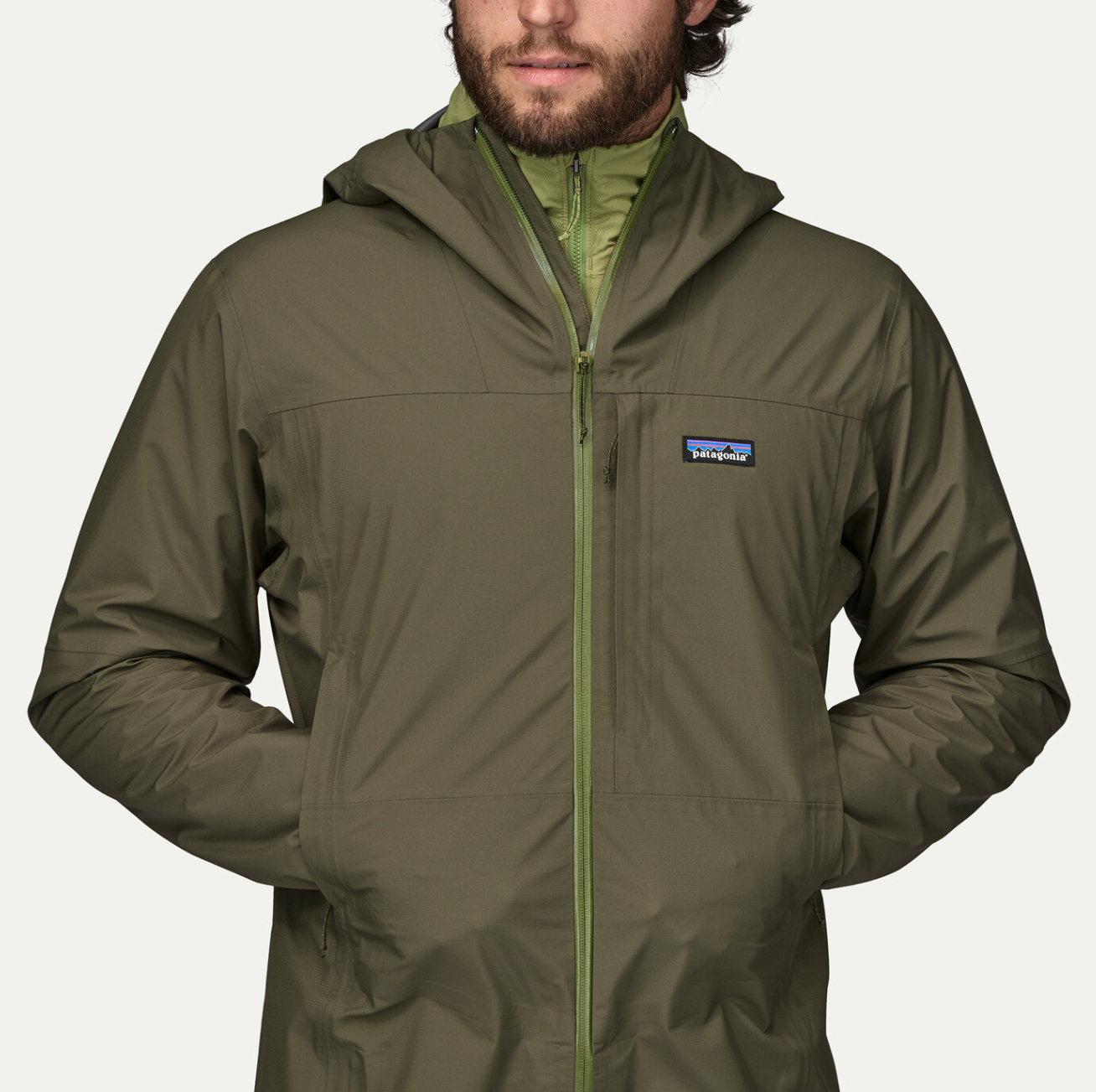 Model with hands in pockets wearing Patagonia Boulder Fork Rain Jacket.