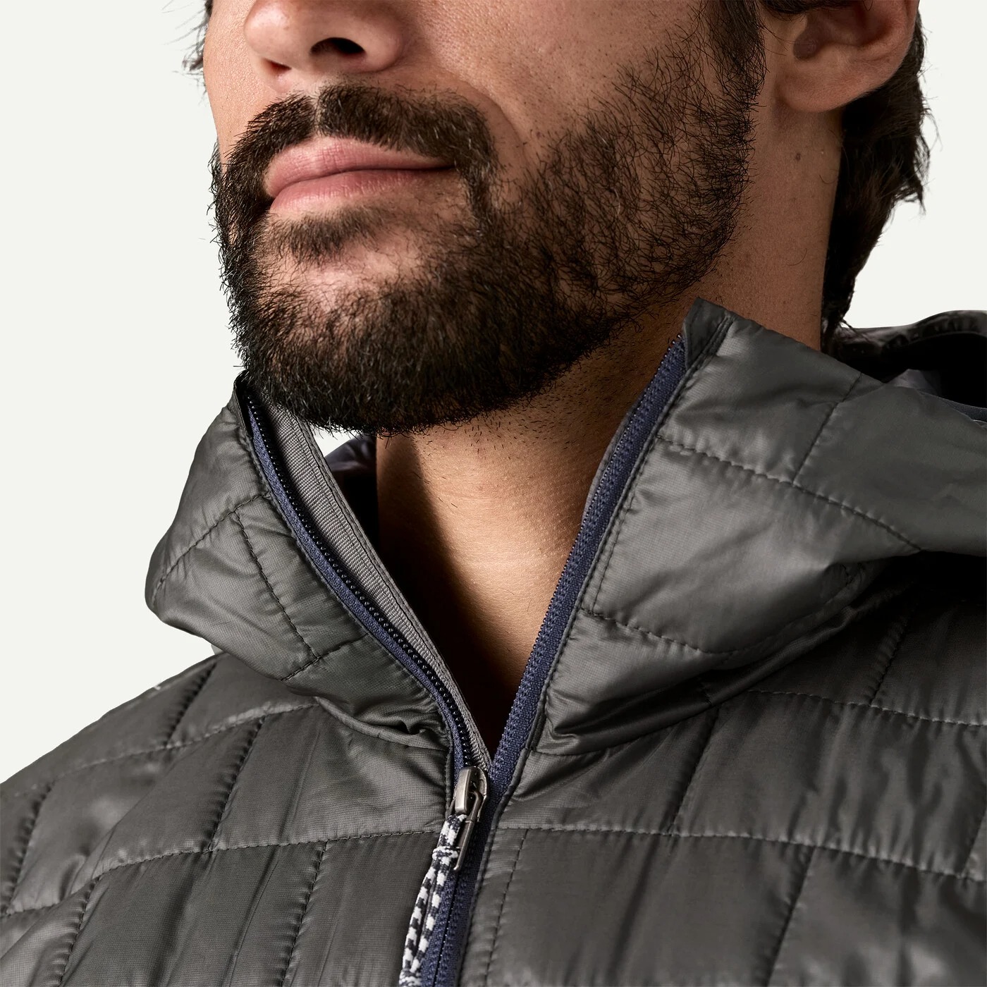 Lightweight insulated outdoor jacket with center zipper and chin guard for cold-weather layering