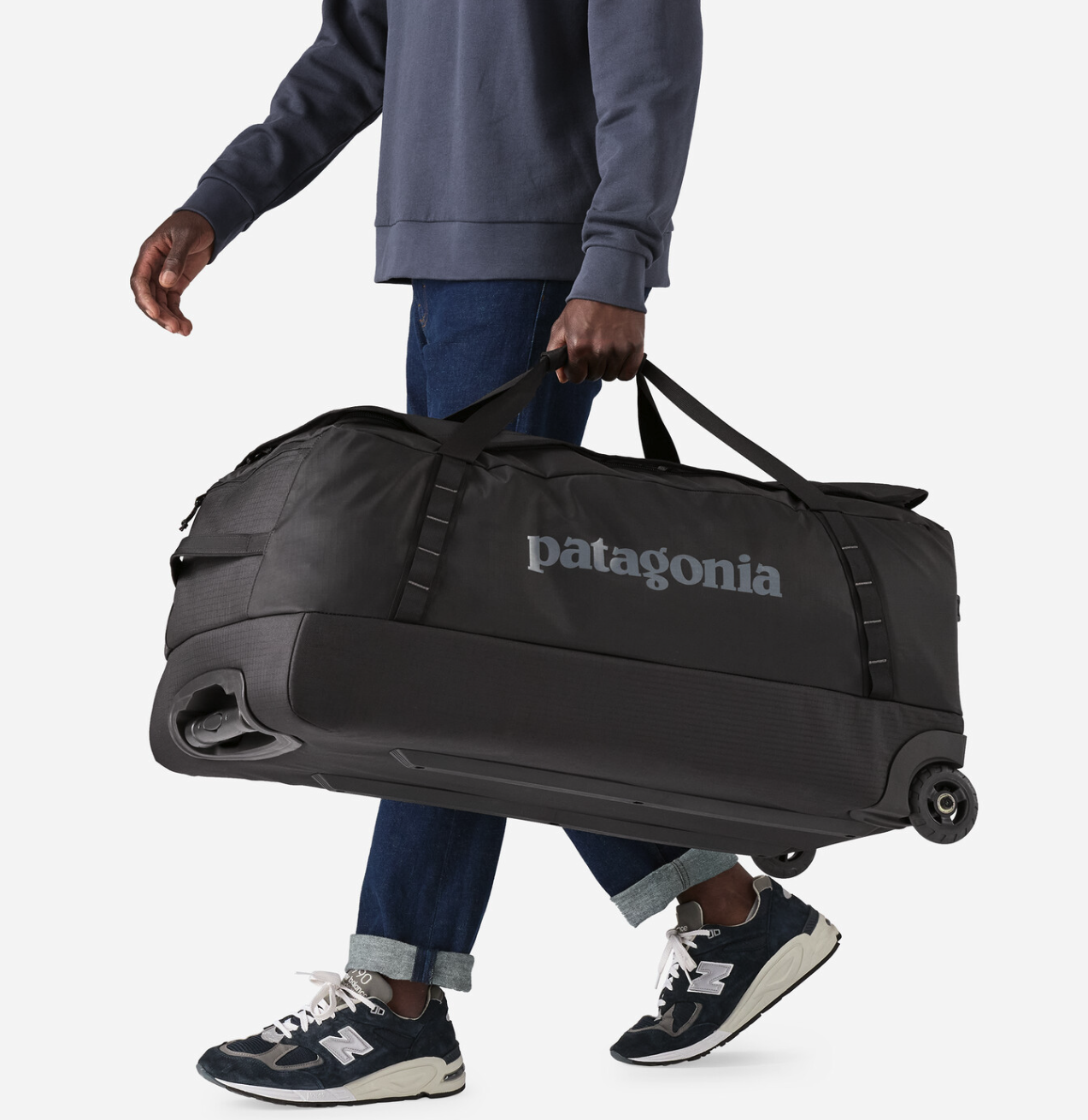 Patagonia Black Hole Wheeled Duffel bag in use, perfect for long trips and outdoor expeditions.