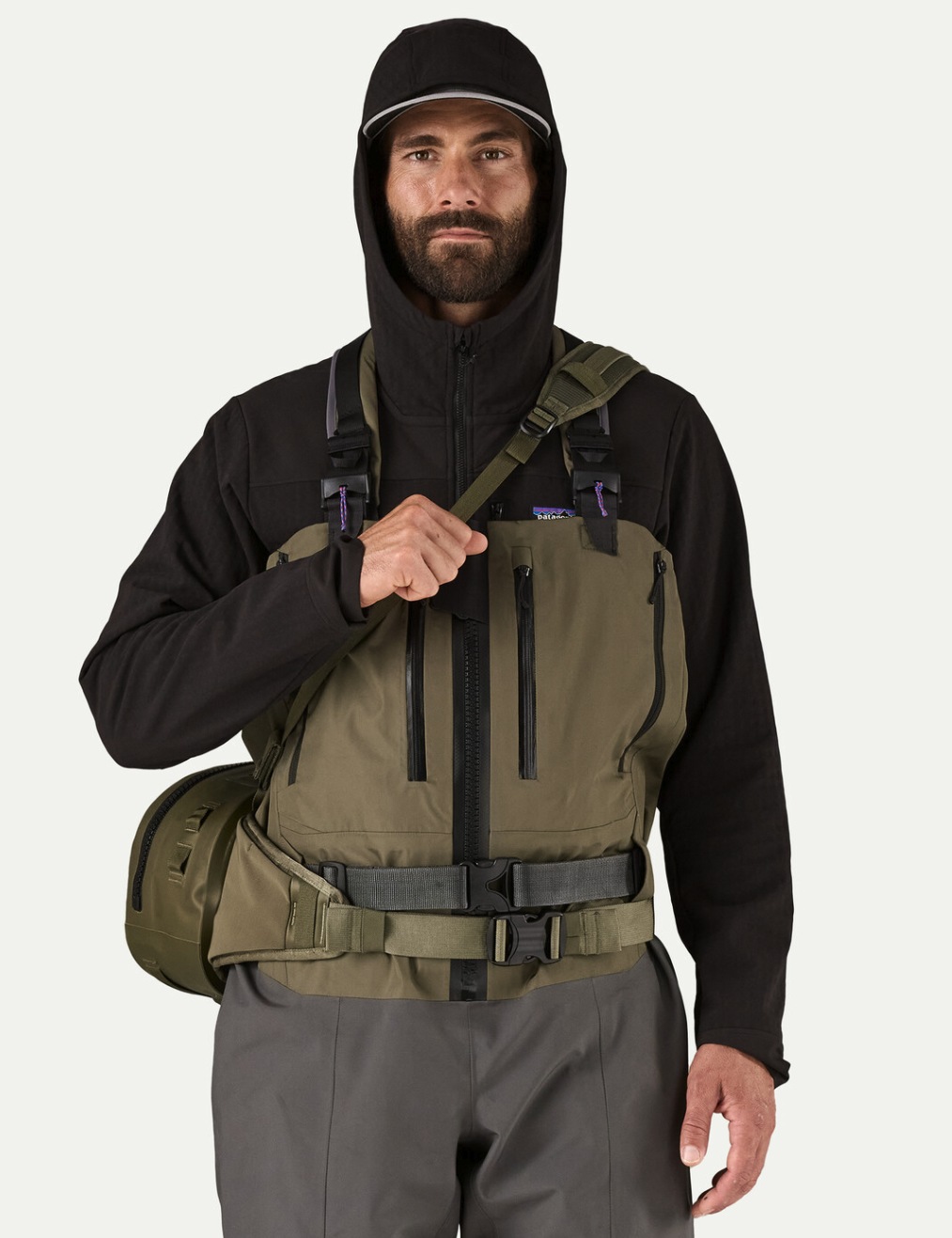 Front view of man wearing  Patagonia Guidewater Hip Pack Basin Green