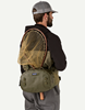 Rear view of angler with net in  Patagonia Guidewater Hip Pack Basin Green