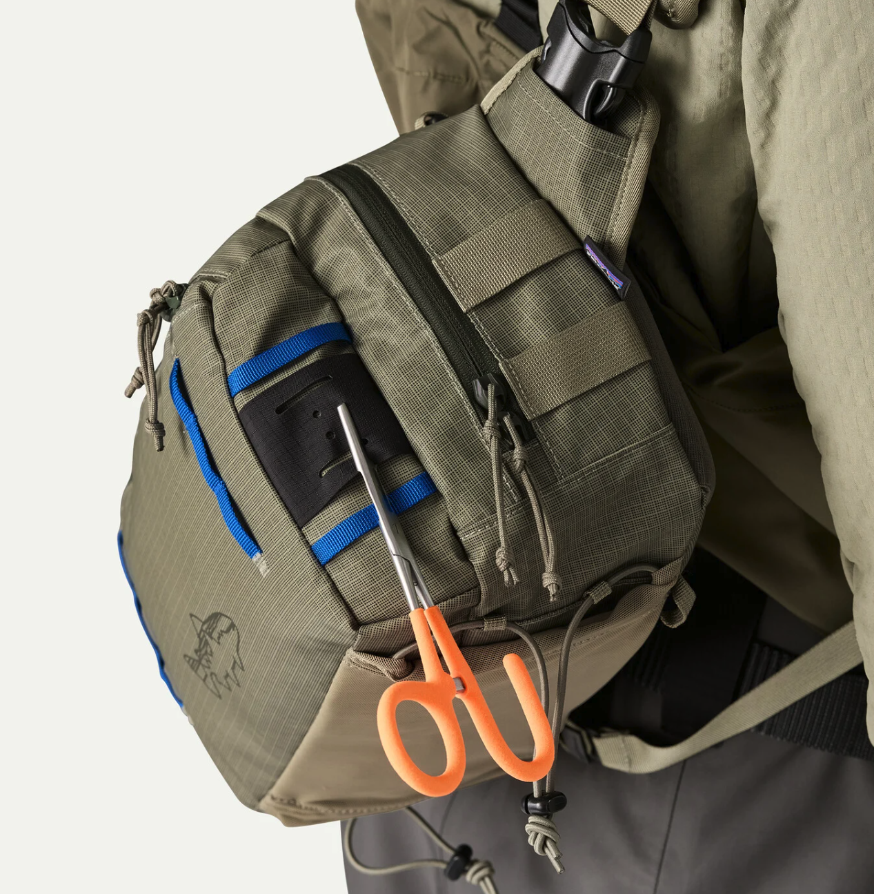 Hemostat hanging from Patagonia Stealth Switch Fishing Pack 9L