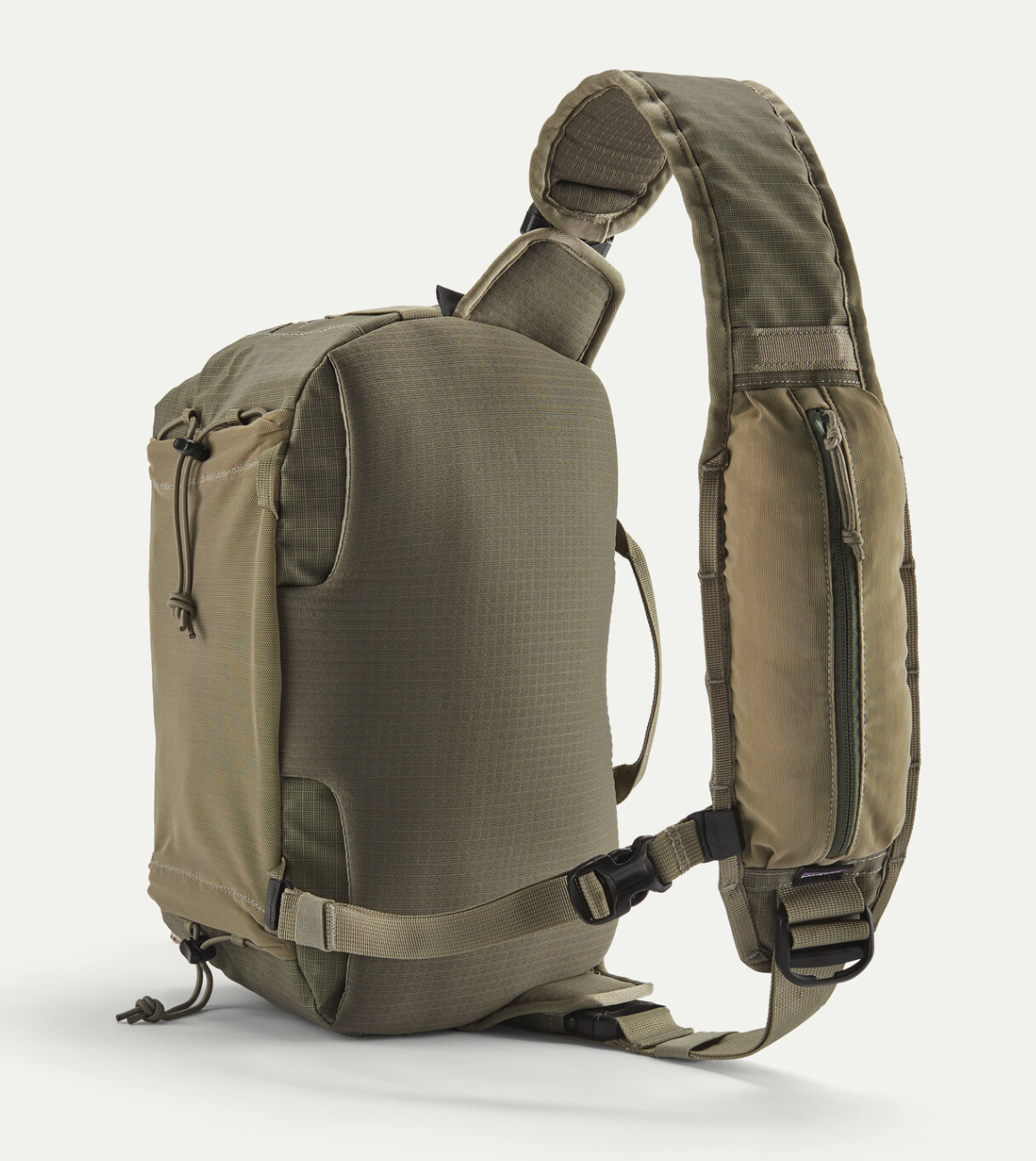 Front strap angle of Patagonia Stealth Switch Fishing Pack 9L in river rock green color.